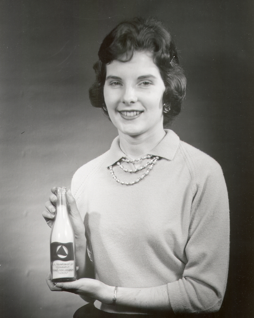 Susan Tully of the USC&GS; Tides Division with a C&GS; current bottle whichwas thrown over board with a note to send back to the USC&GS; detailing where and  when the bottle was found