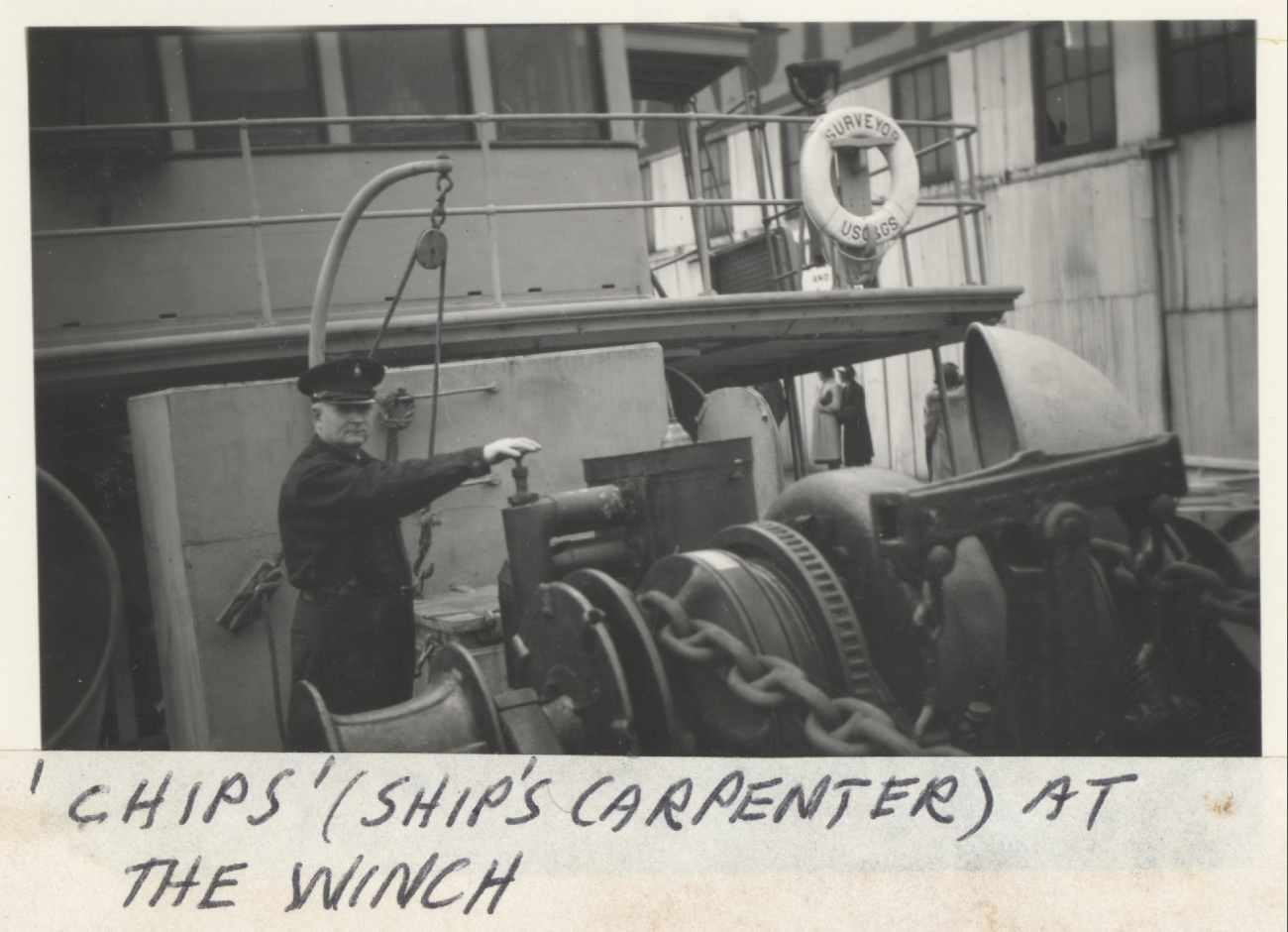 Chips, the ubiquitous name for a ship's carpenter, on the winch of theSURVEYOR