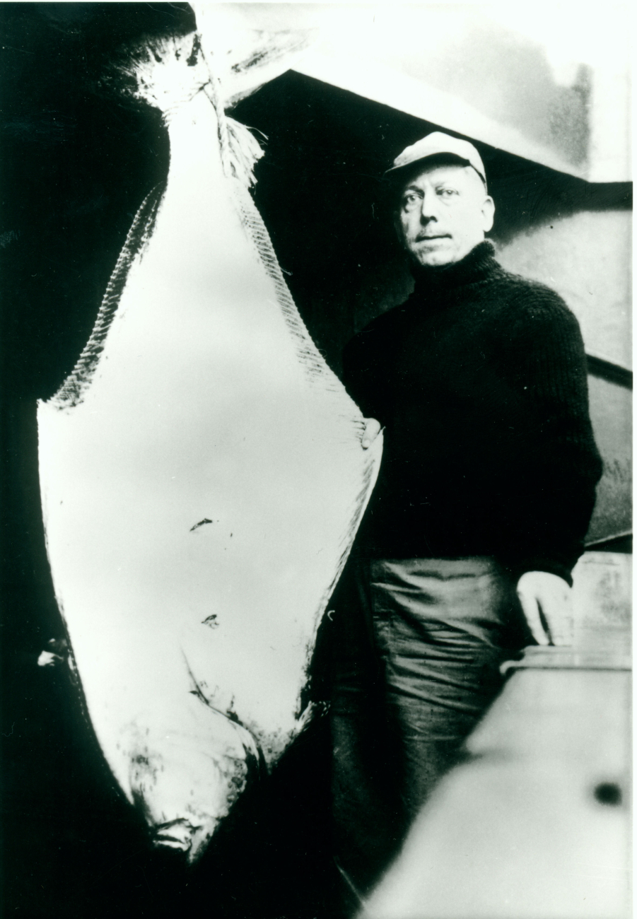 Chief Radioman Ray Helwig with large halibut caught in Aleutian Islands onfishing expedition