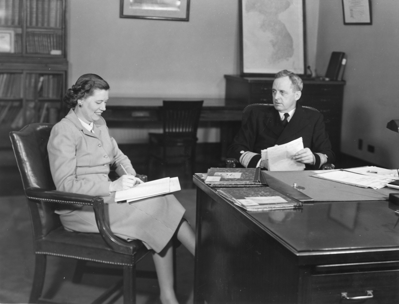 Rear Admiral Robert Knox dictating letter to secretary Eleanor Carr