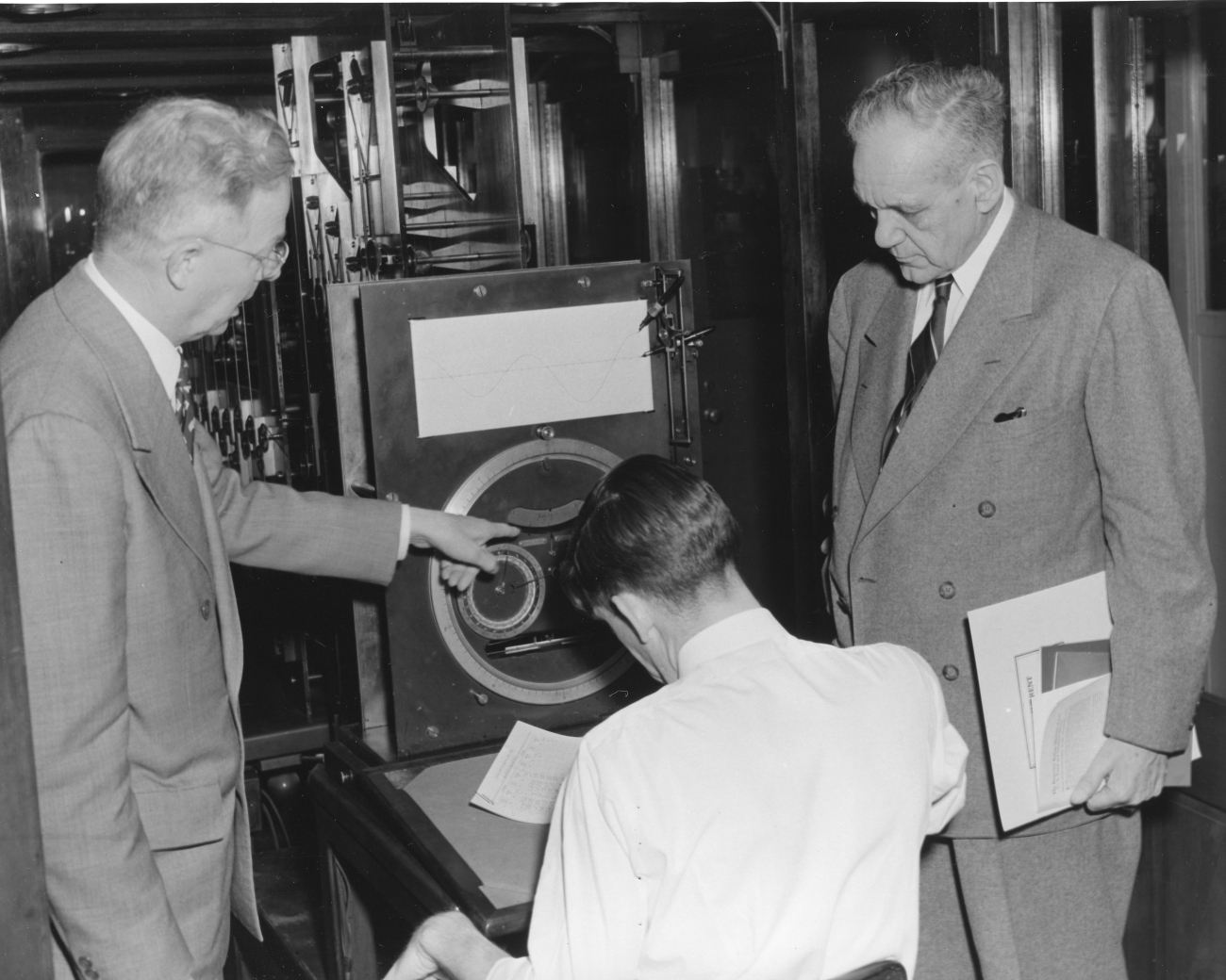 Congressman Campbell of Florida receiving demonstration of old Brass Brains,the mechanical tide prediction machine