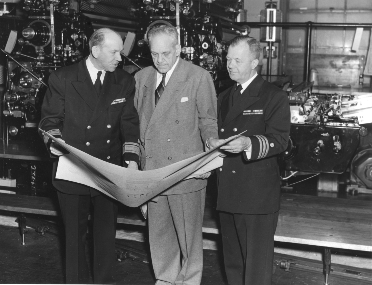 Congressman Campbell of Florida being briefed on chart printing process byRear Admiral Robert Studds and Commander Alvin C