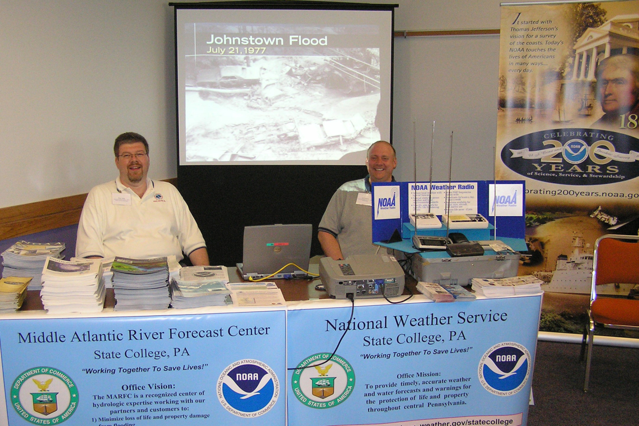 Peter Jung, Senior Hydrologist, and William Gartner, Forecaster, staff a boothat the Open House hosted  by the co-located NWS Forecast Office and MiddleAtlantic River Forecast Center facility in State College, Pennsylvania