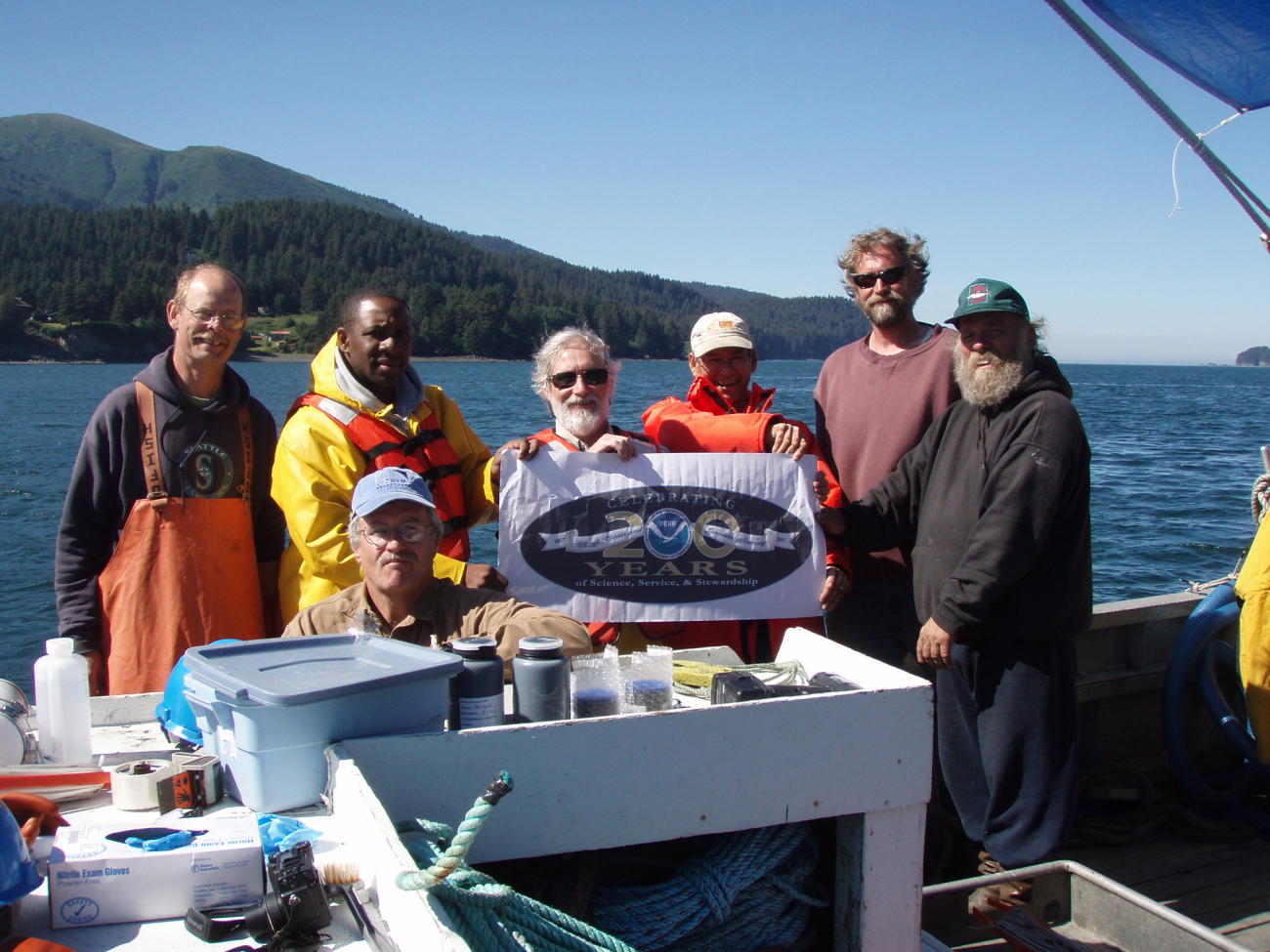 National Status & Trends Program scientists from NOAA's Center for CoastalMonitoring and Assessment pose with their collaborators aboard the fishingColumbia, including a representative of the Alaskan Native village ofPort Graham