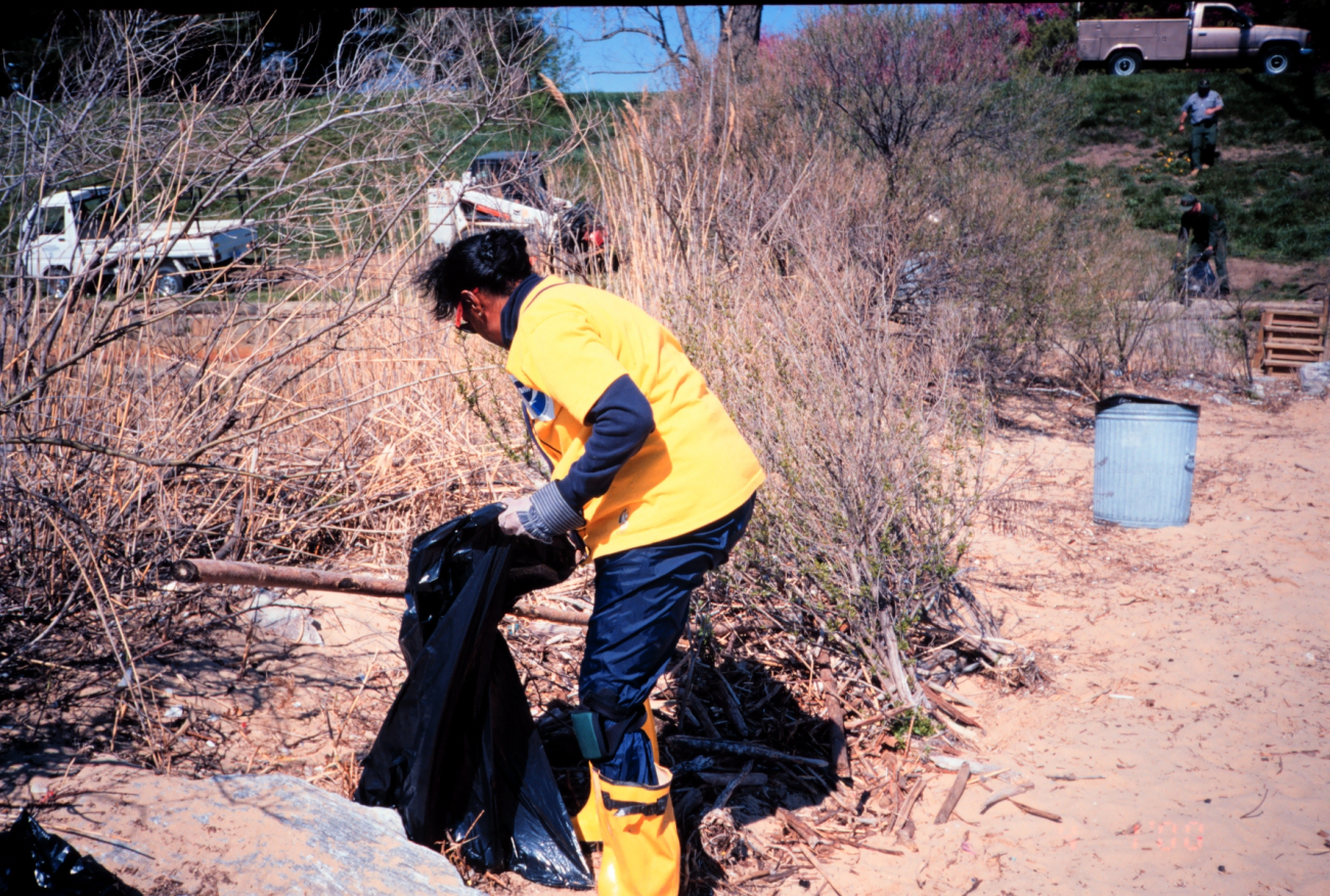 Margaret McCalla of NOAA cleans trash off the beach at Ft