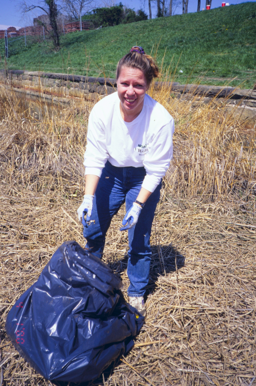 A volunteer hauls trash removed from the site