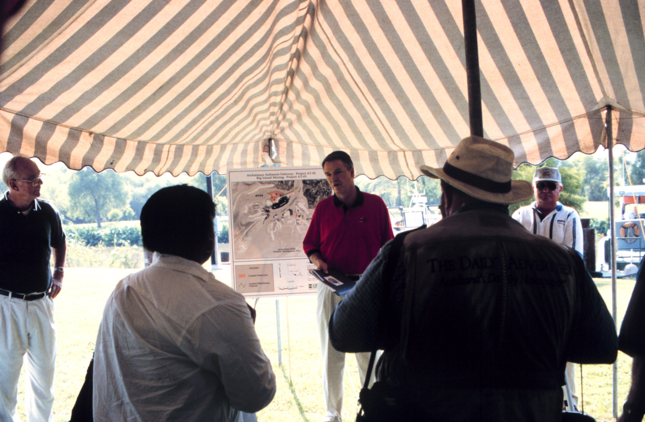 Senator Breaux in front of a map of the restoration project