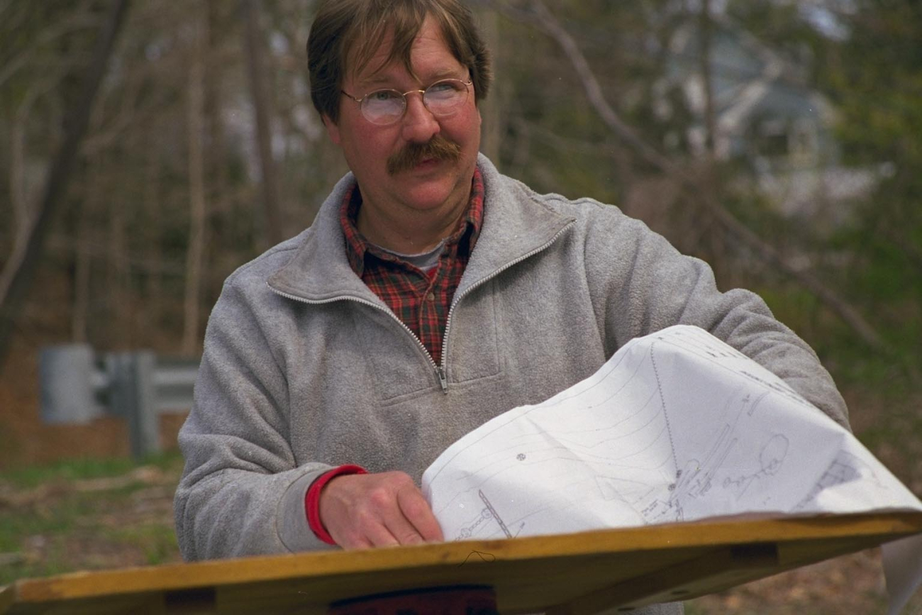 A surveyor reads the chart that tells him exactly where the historical dam thatis scheduled for removal is located