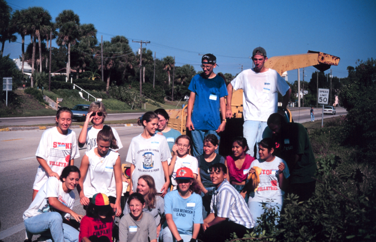 A local school group poses after the removal effort
