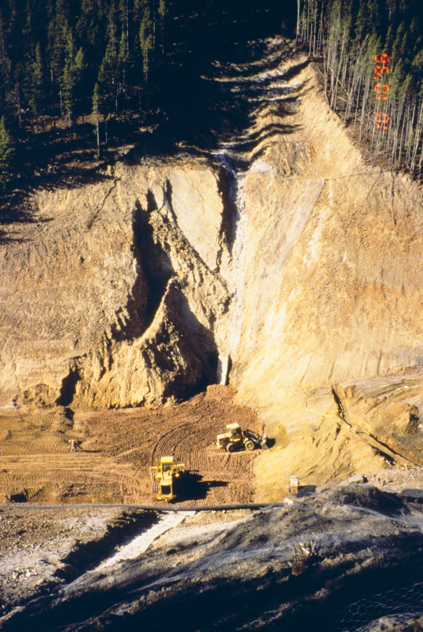 Dumping materials into a large open pit at Blackbird Mine as part of theclean-up work