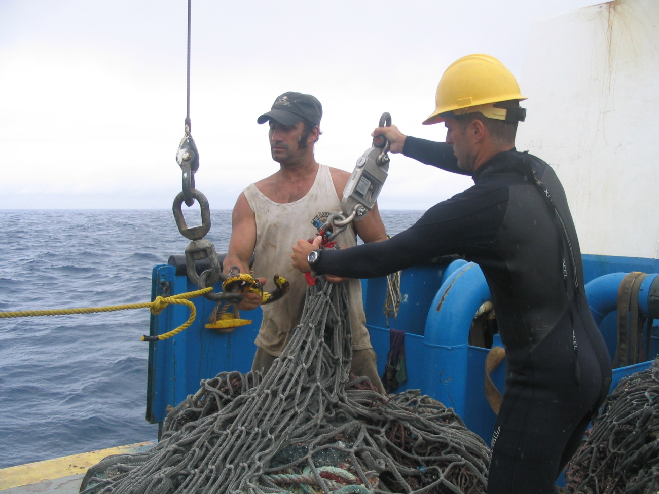 Preparing to weight derelict net that had just been lifted onto the CASITAS