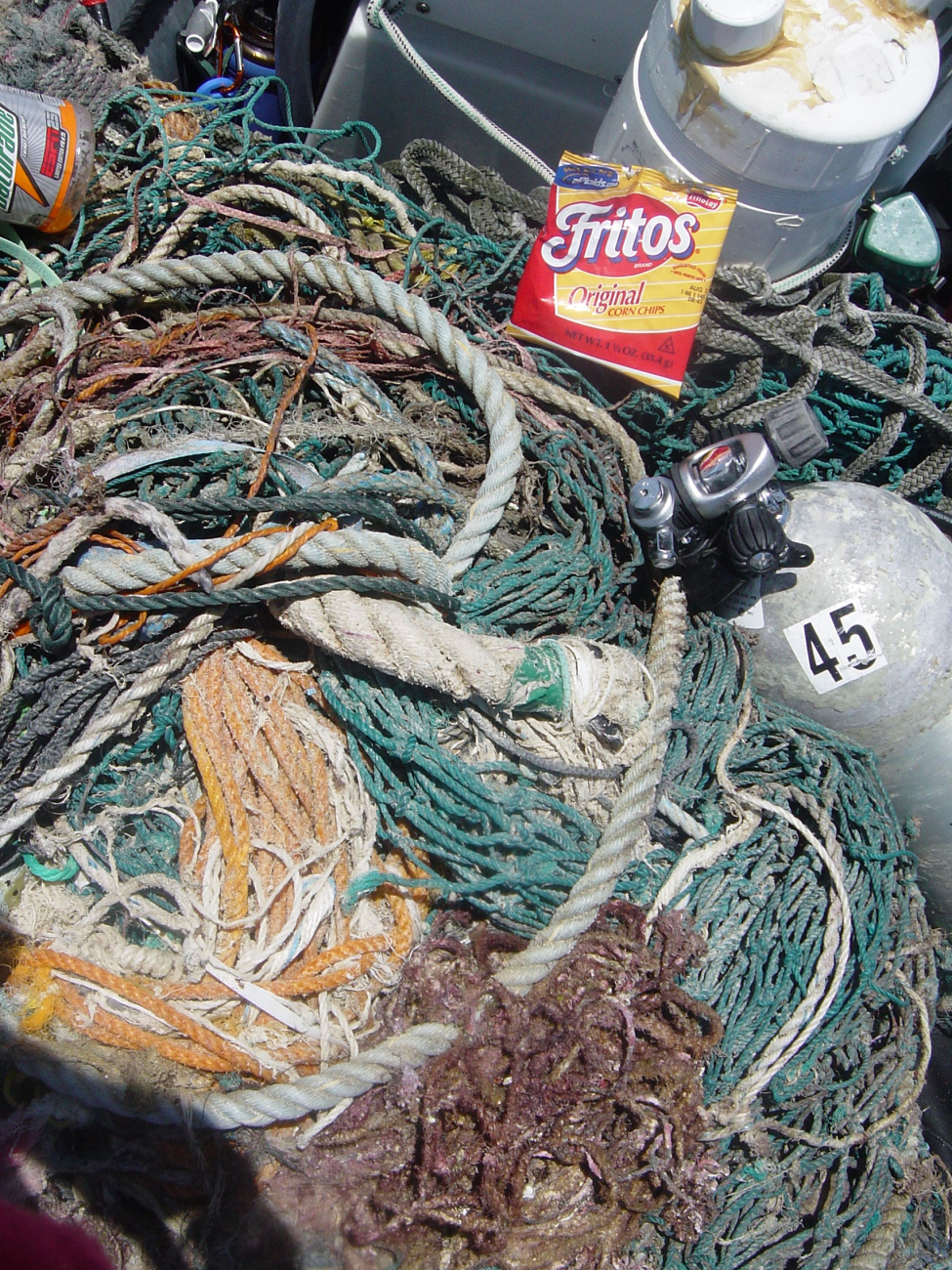Scuba gear, remains of lunch, and derelict net on small craft prior to return to ship