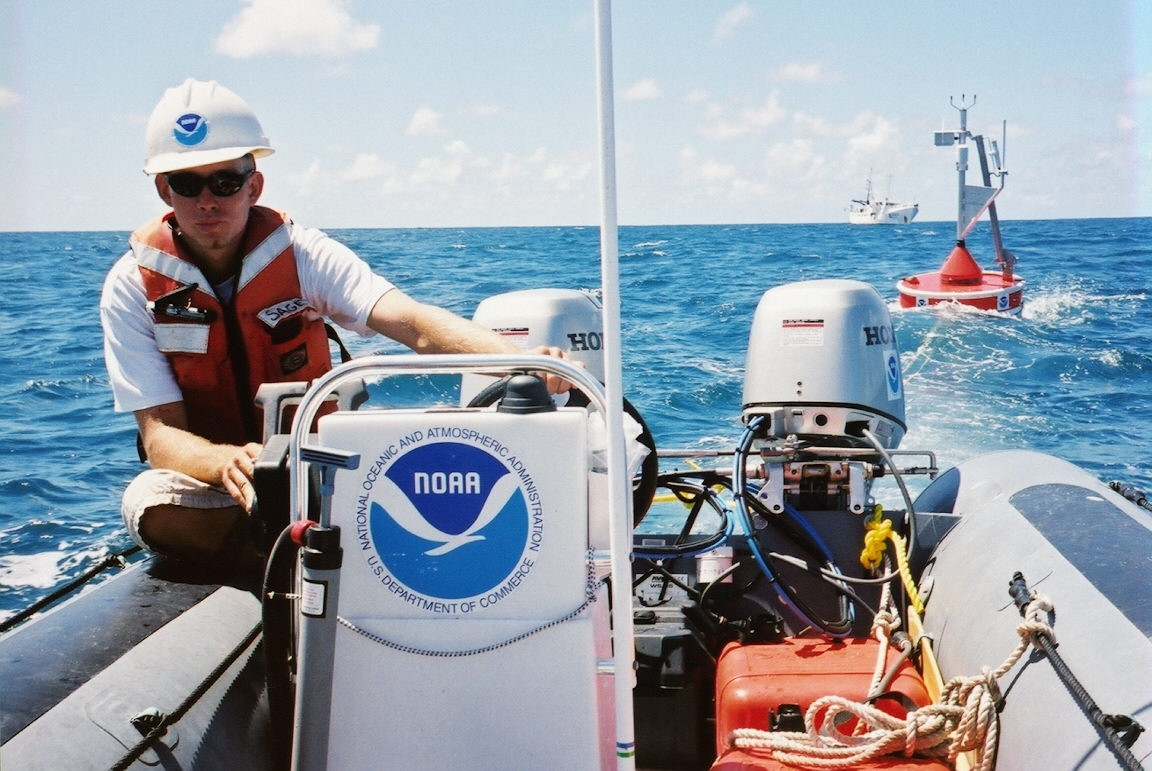 A CREWS buoy is towed from NOAA ship TOWNSEND CROMWELL for deployment inshallow water
