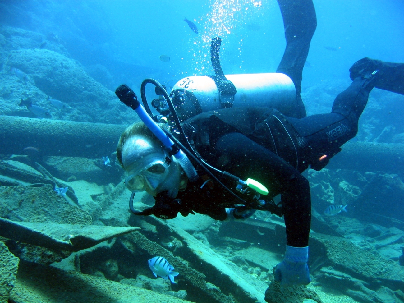 Diver inspecting modern ship wreck on Pearl and Hermes Reef
