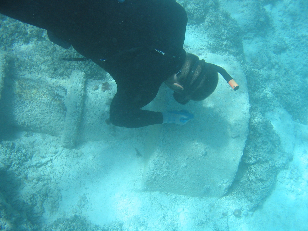 Diver inspecting sunken buoy