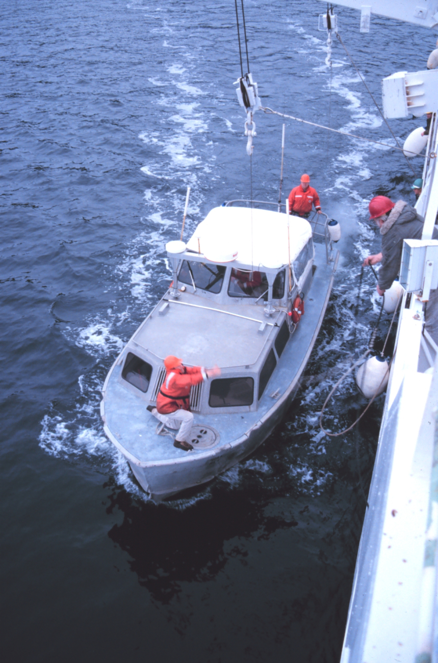 RA-1 boat pulls alongside the RAINIER prior to being hoisted out of the water