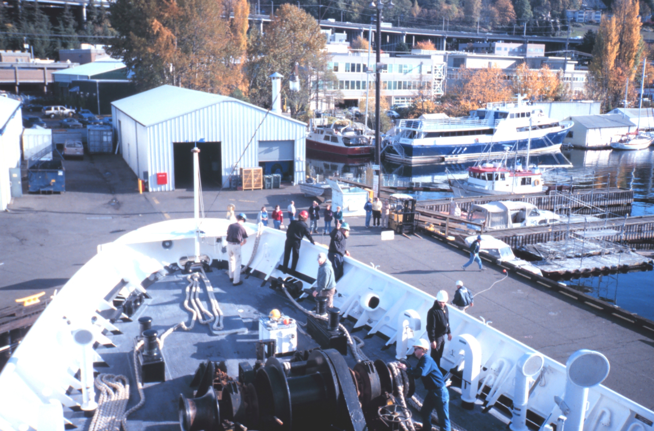 Chief Boatswain Jim Kruger (in green hard hat) directs RAINIER Deck Departmentpersonnel as the RAINIER returns home to Seattle and its base at thePacific Marine Center