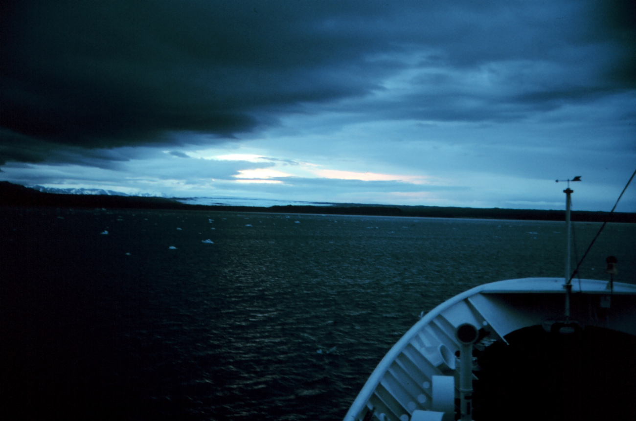NOAA Ship RAINIER approaching the coast at twilight at Icy Bay