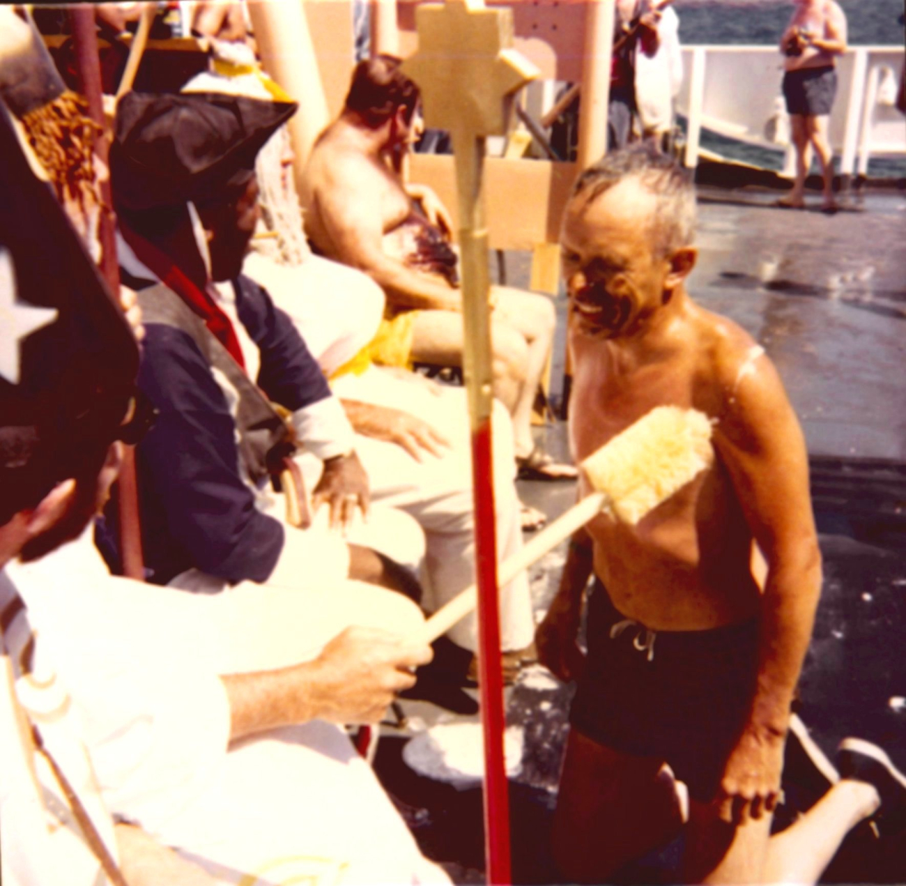 Monte Poindexter receiving being dubbed by the royal sceptre during Equatorcrossing ceremonies on the ESSA Ship DISCOVERER