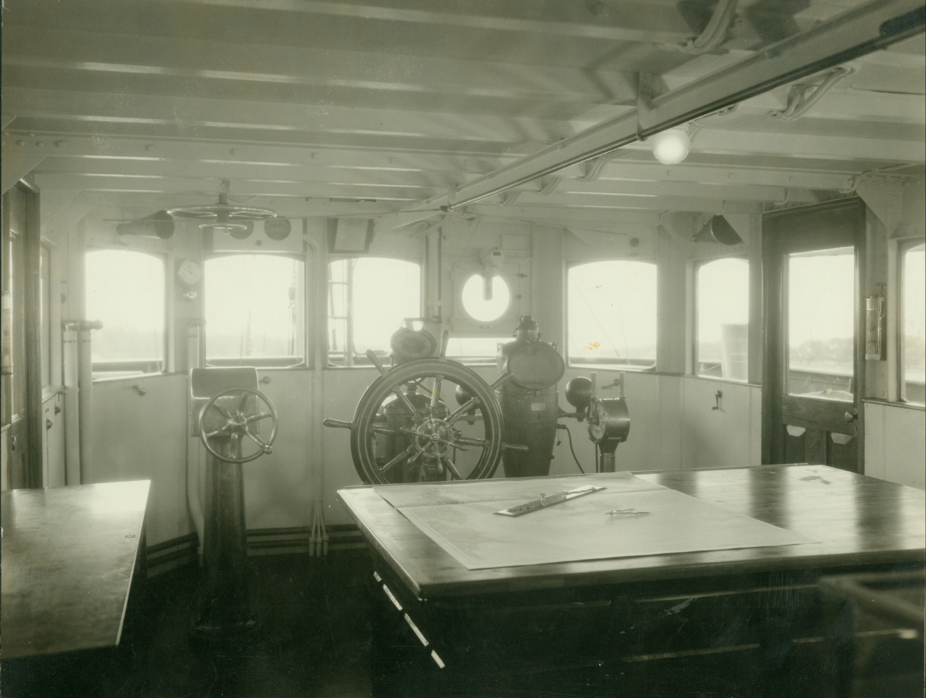 Pilot house of USC&GS; Ship HYDROGRAPHER showing bridge control for propulsion motor, automatic steering, gyro-compass repeater, clear vision disc,and engine room telegraph