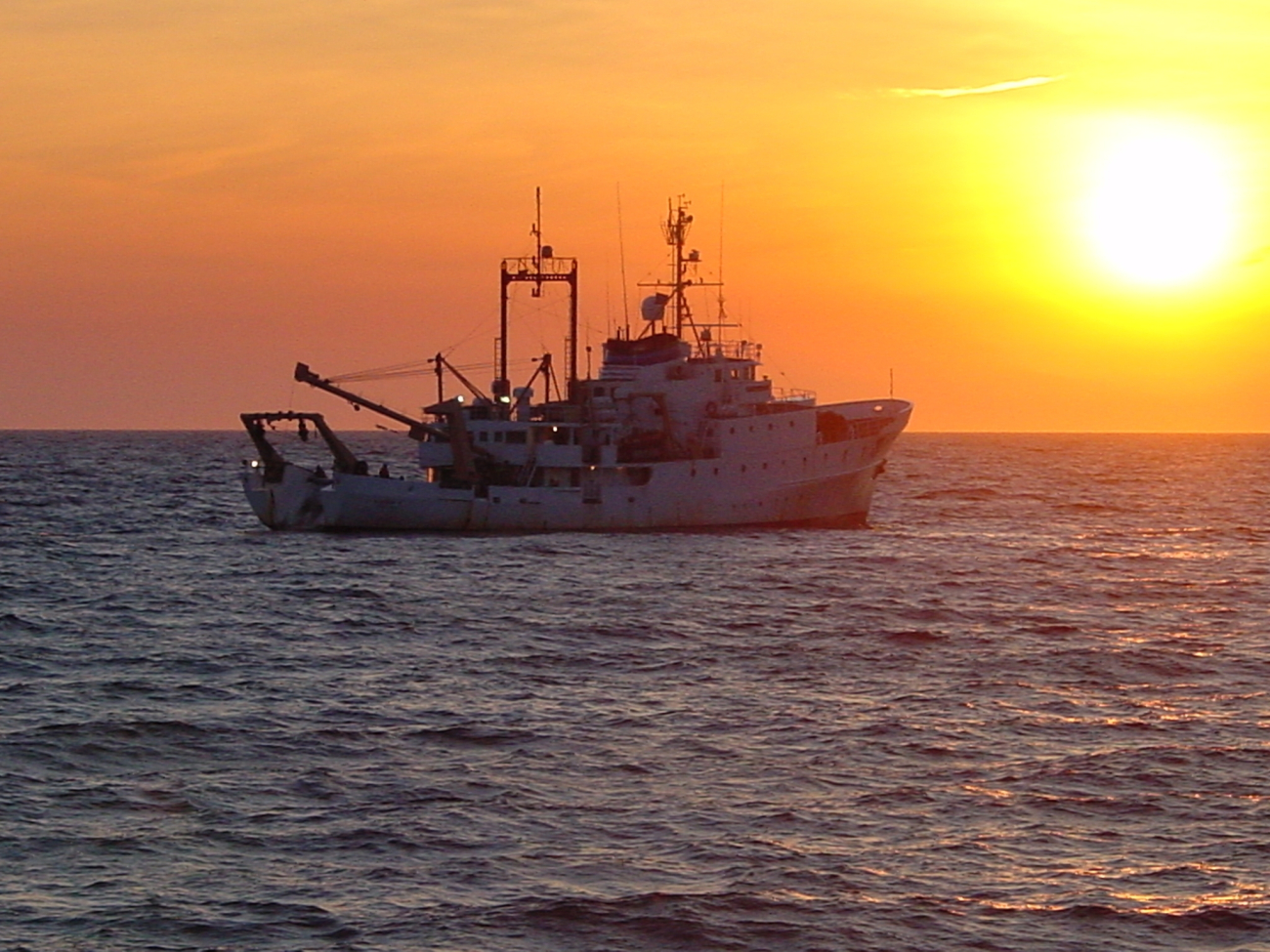 NOAA Ship ALBATROSS IV with trawling into the sunset