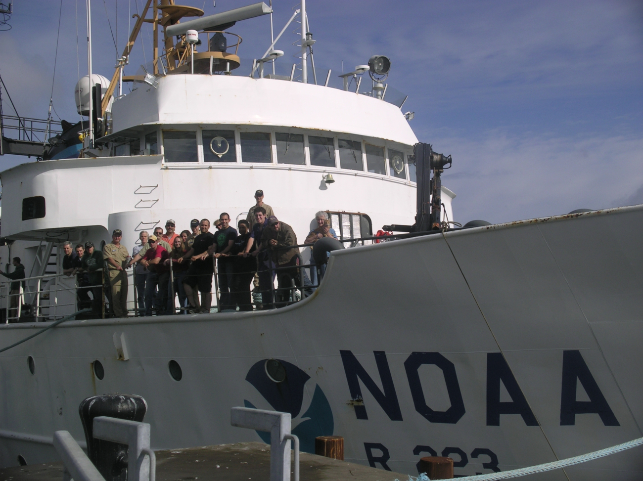 NOAA Ship MILLER FREEMAN officers and crew posing on the bow of the ship