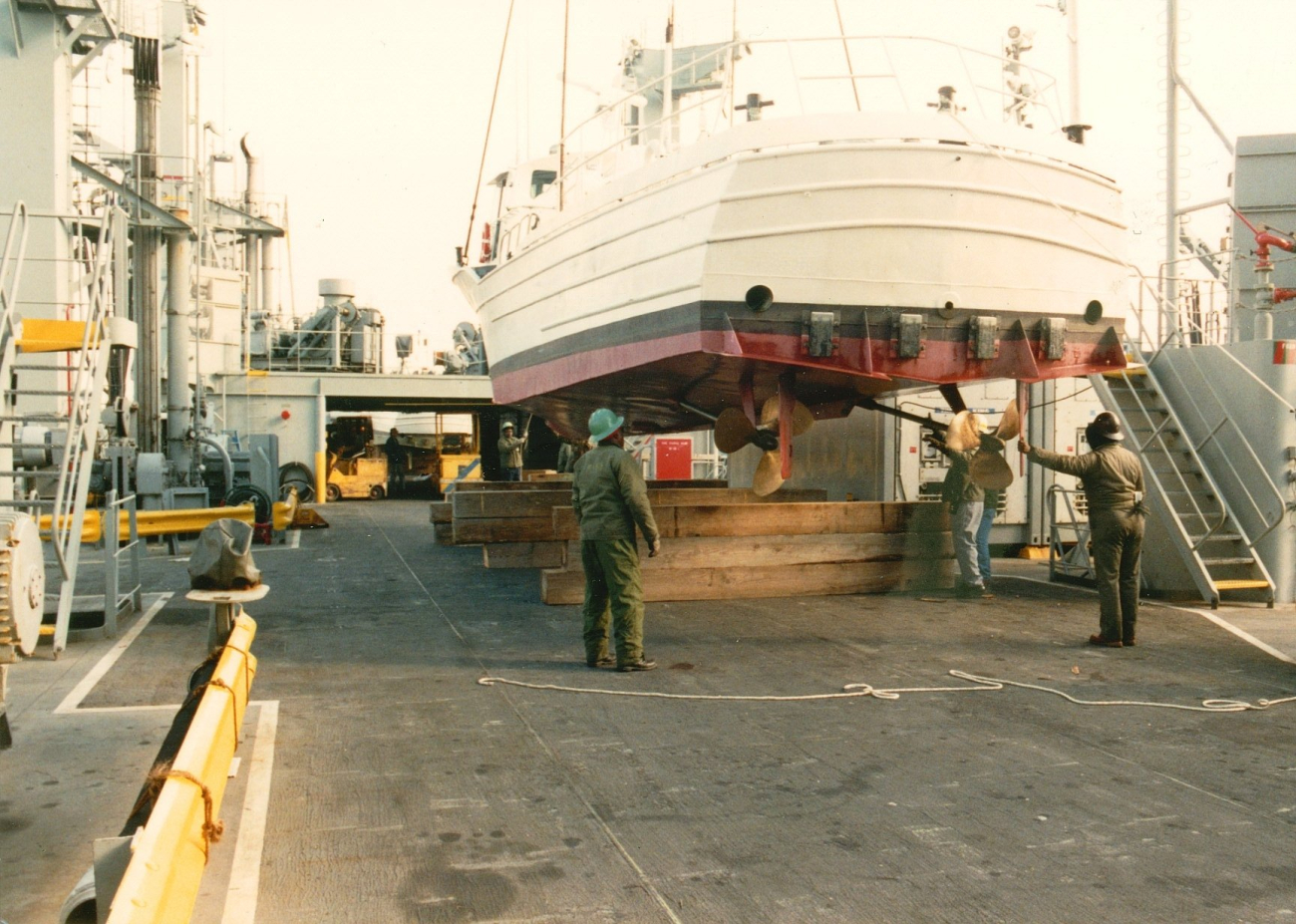 NOAA Launch 1257 being lowered to deck of  USNS cargo ship prior totransport and transfer to government of Malta