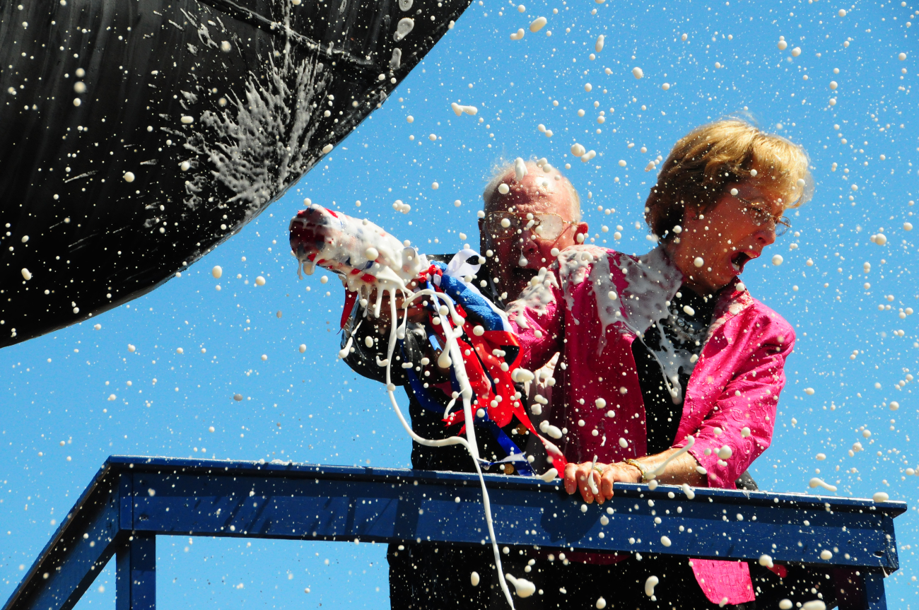 Susan Lautenbacher, wife of NOAA Administrator Conrad Lautenbacher, breaksbottle of champagne on bow of BELL M