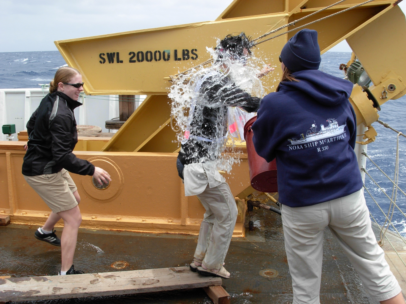 Pollywog walking the plank while shellbacks enhance the experience duringequator crossing ceremony on the NOAA Ship KA'IMIMOANA (R333)