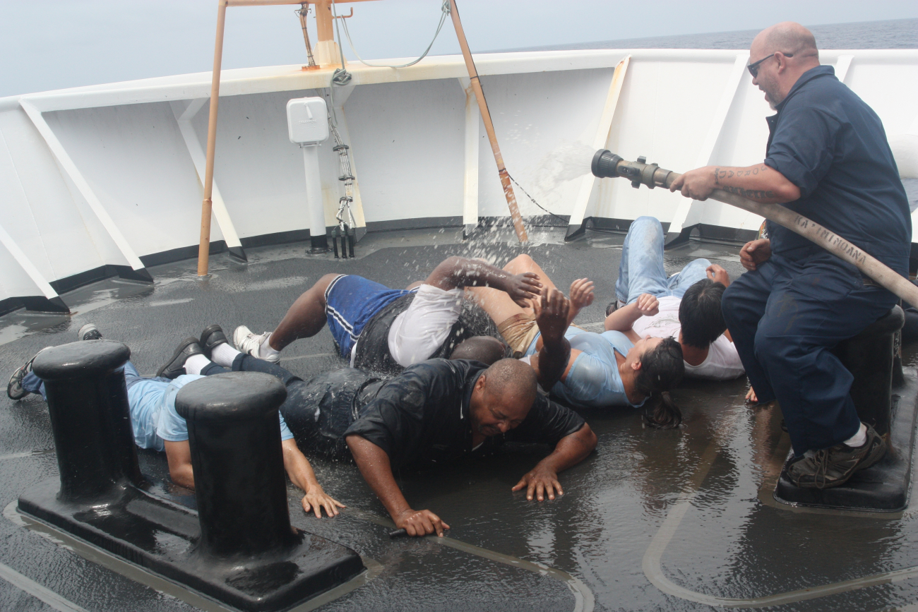 Shellback helping cleanup pollywogs during equator crossing ceremonies on theNOAA Ship KA'IMIMOANA (R333)