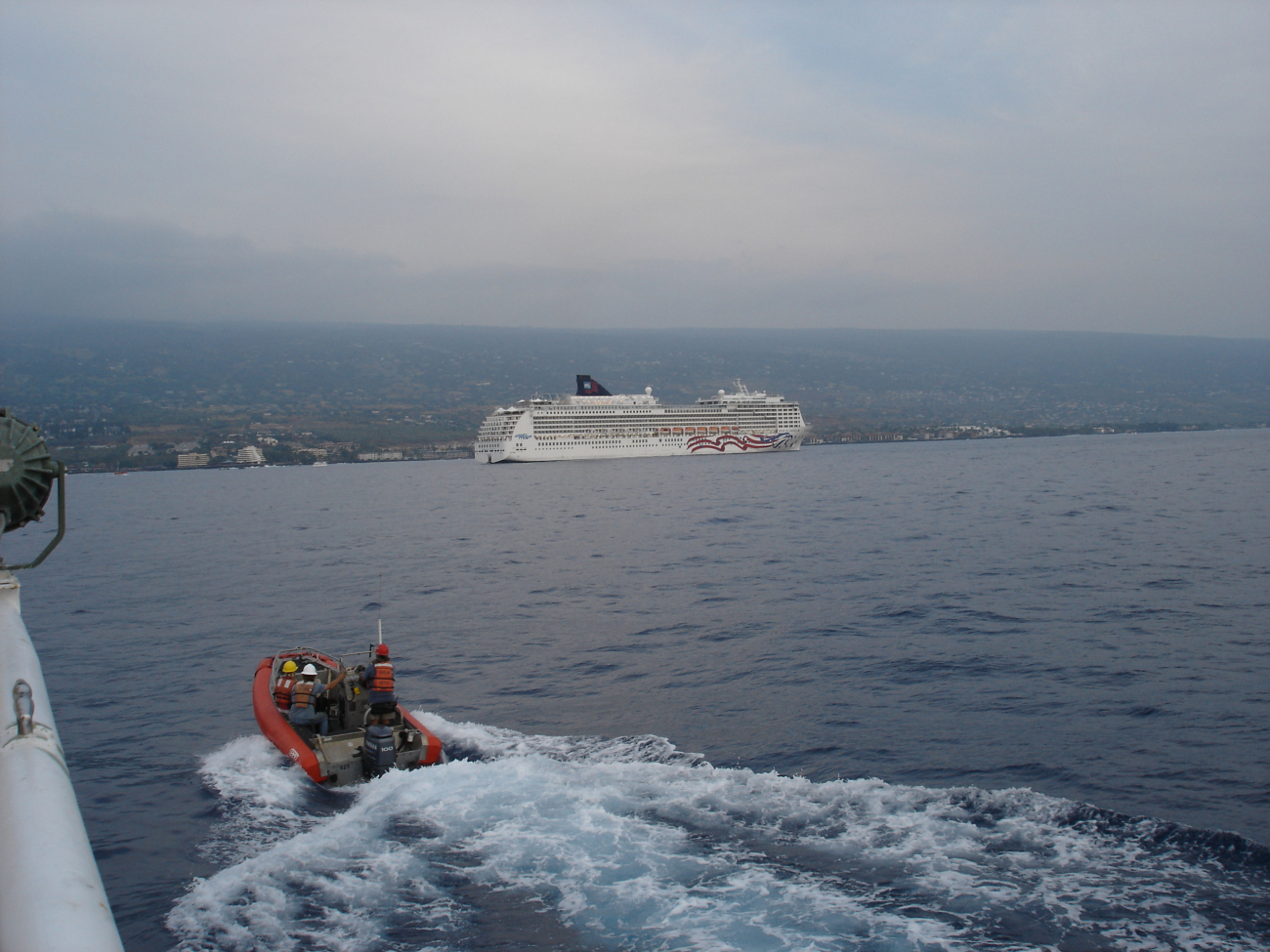 Inflatable boat leaves the NOAA ship OSCAR ELTON SETTE while the cruiseship PRIDE OF AMERICA is anchored offshore