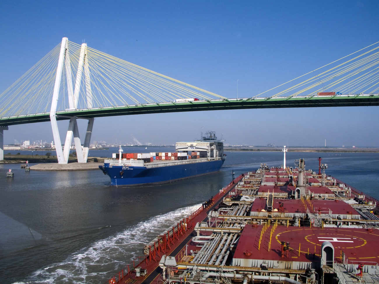 A container ship and a tanker passing each other at the Sunshine SkywayBridge in Tampa