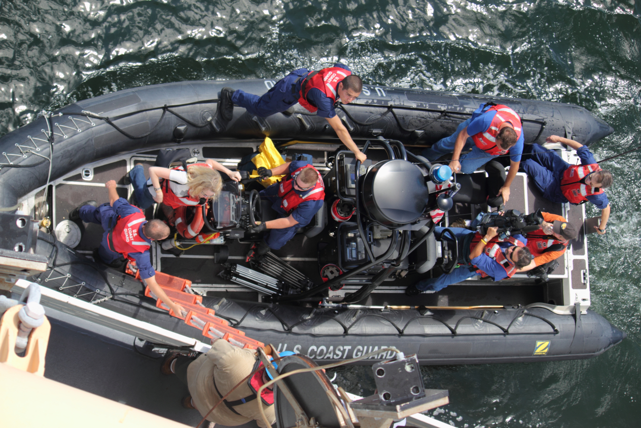 United States Coast Guard rigid-hull inflatable boat discharging personnel onNOAA Ship PISCES