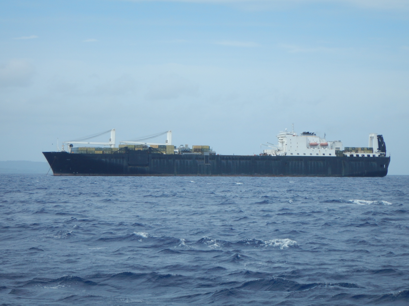 Military Sealift Command vessel anchored offshore from Saipan