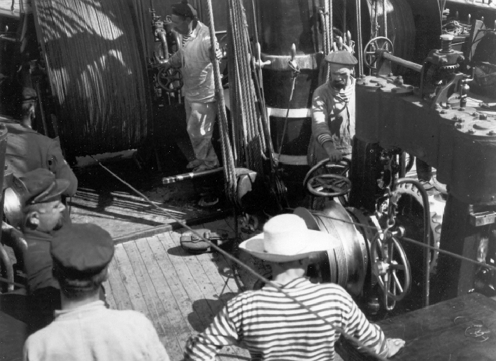 A view of sailors at their stations operating winches during oceanographicoperations