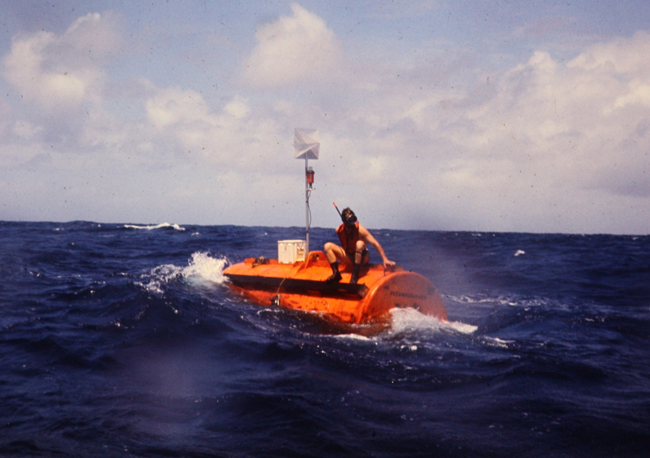 Deep sea mooring buoy attached to anchoring system being deployed