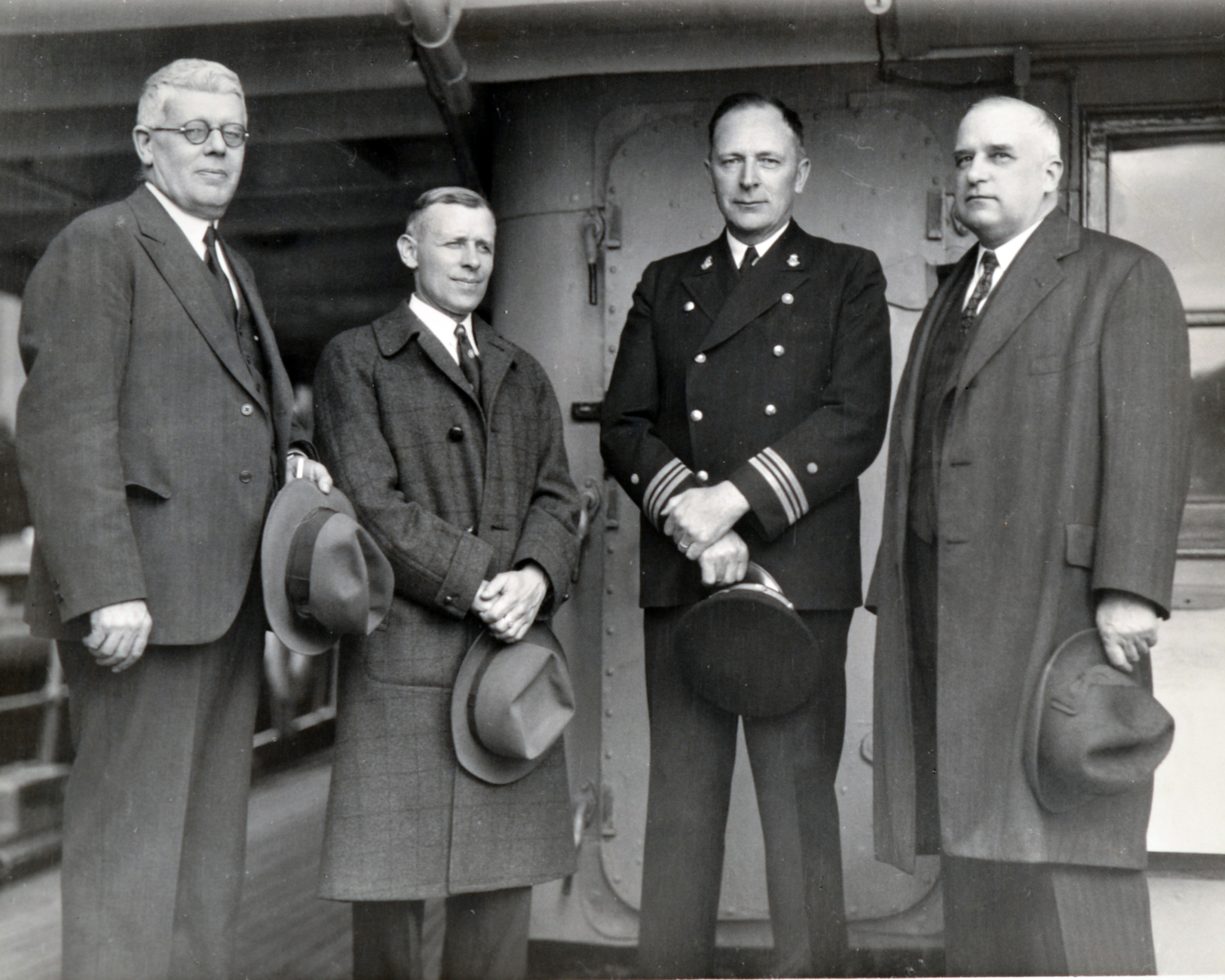 From L-R, Captain Hardy, unidentified, Lieutenant Commander Ray Schoppe,and Commander Sobieralski on the SURVEYOR attending launchingceremony of the USC&GS; Ship EXPLORER