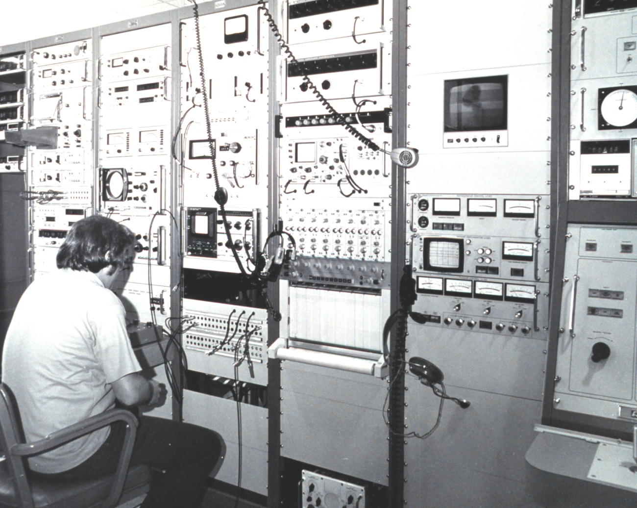 An engineer checking some of the electronics associated with satellite datareception and processing