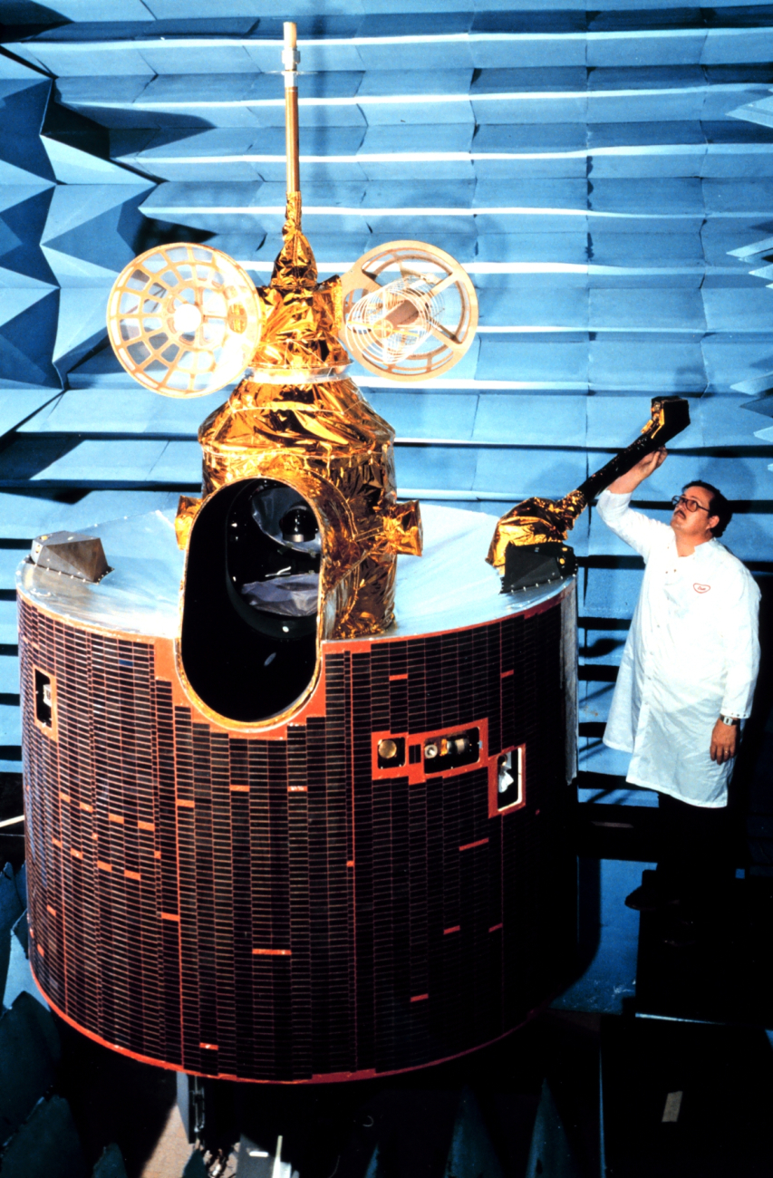 Scientist working on GOES-D model satellite prior to launching