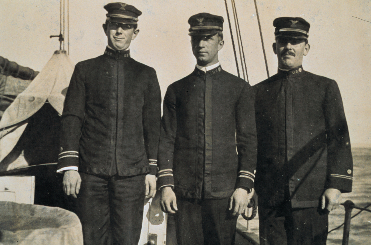 Three unidentified officers on a C&GS; ship