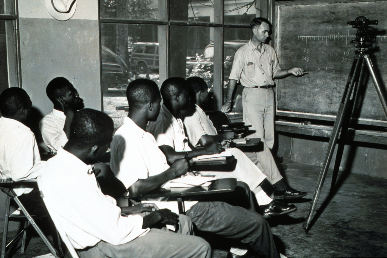 Commander George Morris instructing Liberian engineering students in theuse of surveying instruments