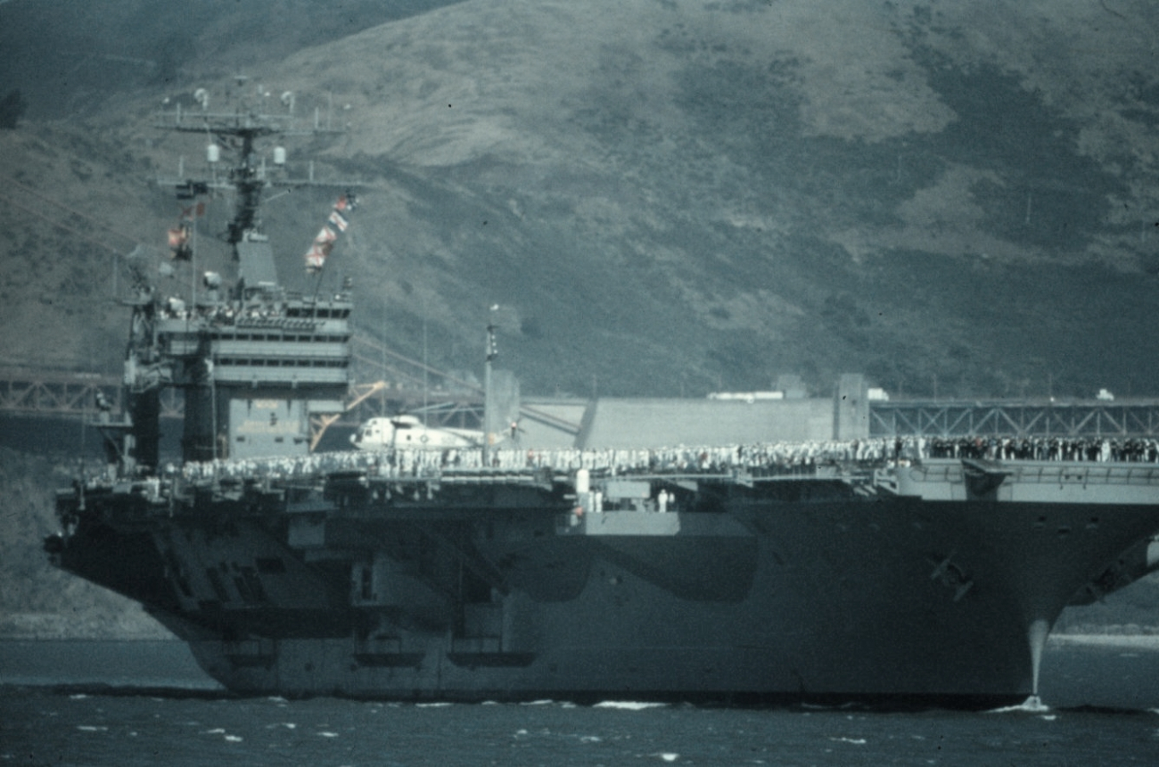 An aircraft carrier in San Francisco Bay fills the field of view
