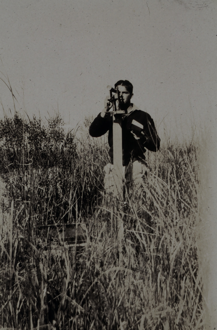 Robert Earle running traverse survey in Cooper River area