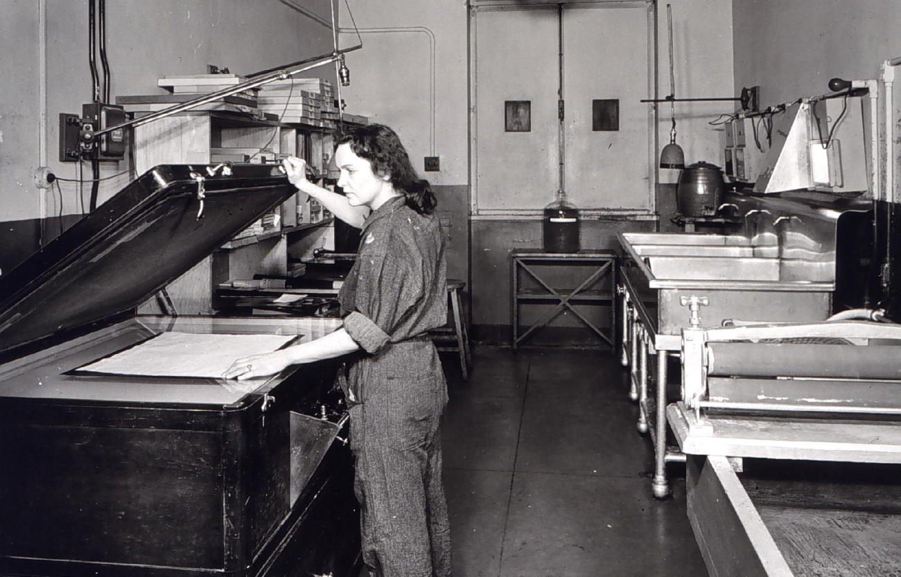 Woman operating photo-reproduction equipment