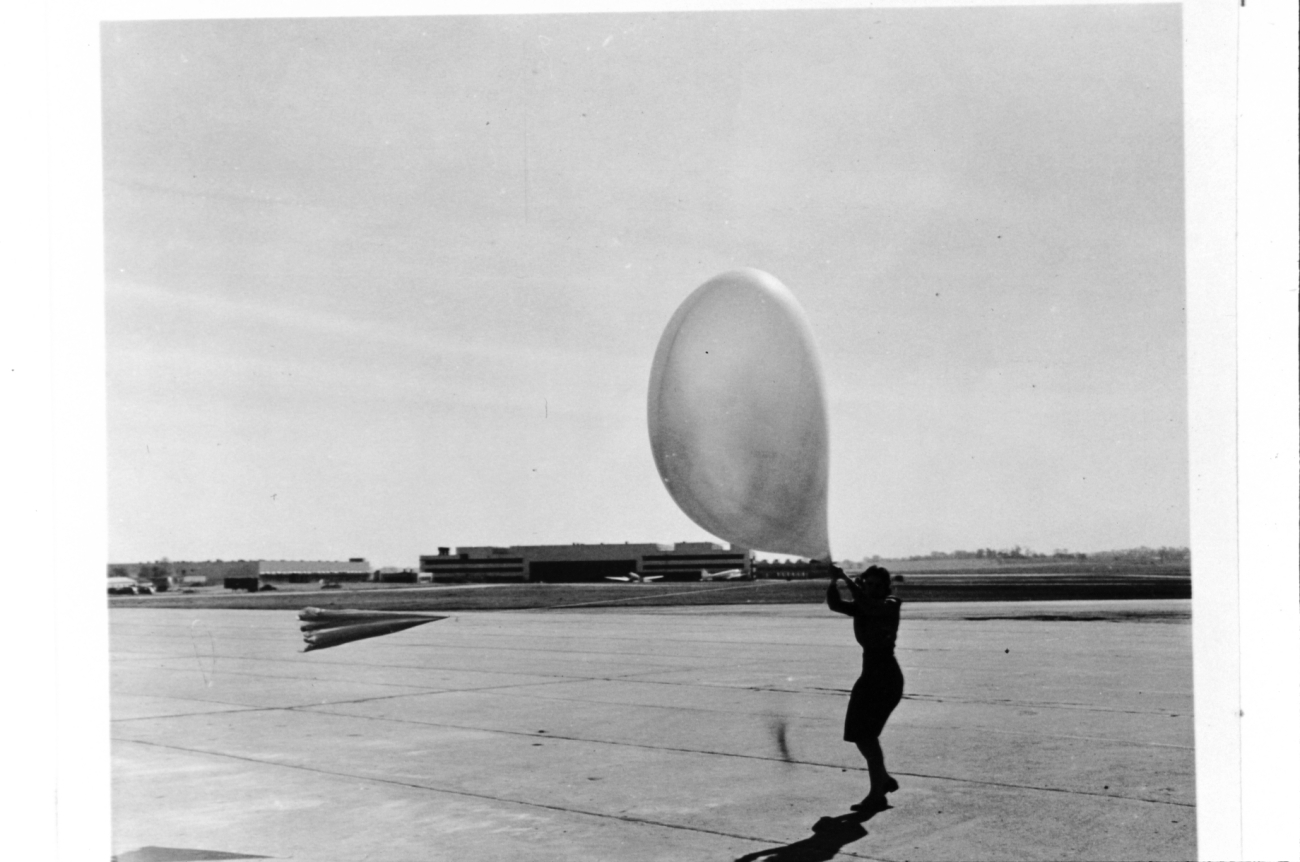 Launching a pilot balloon during strong winds at St