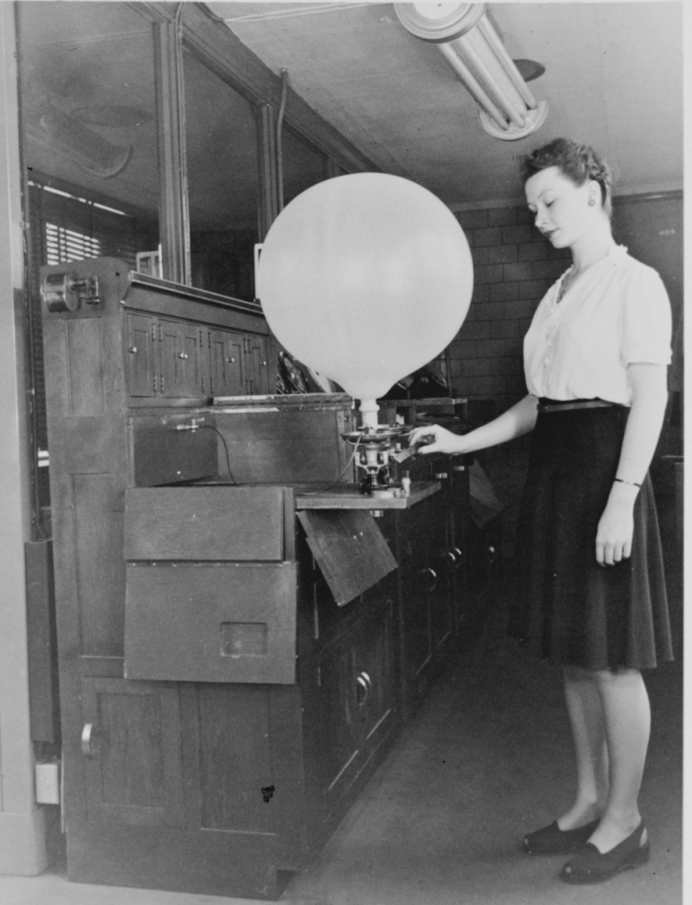 Inflating a pilot balloonWomen's first opportunities in meteorology occurred as a result of WWII