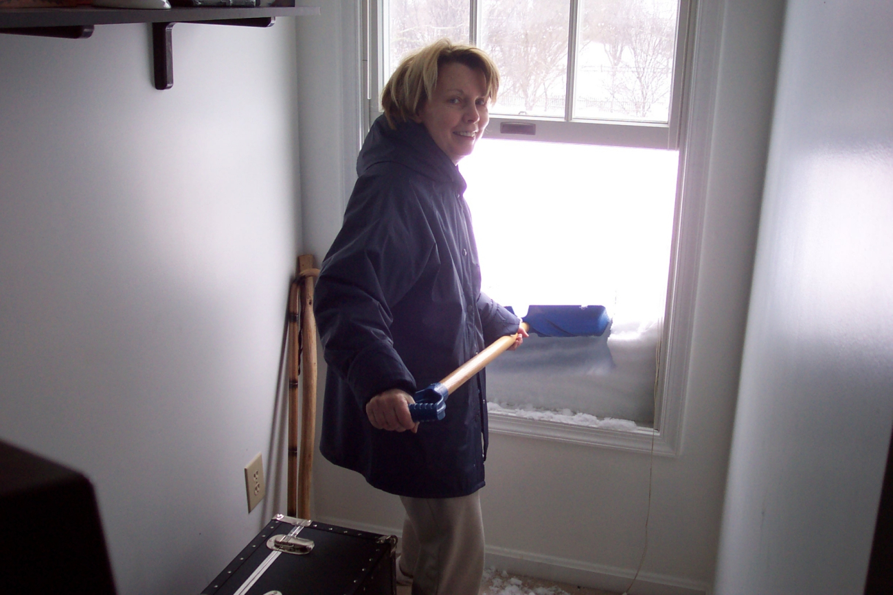 Shoveling off the roof from a second floor bedroom window