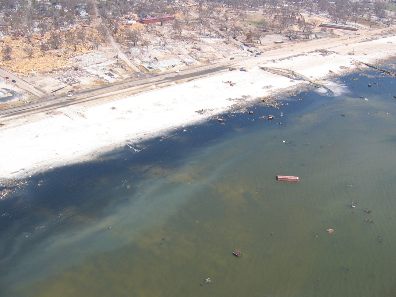 Debris from port facility strewn throughout Gulfport andecological damage to beach