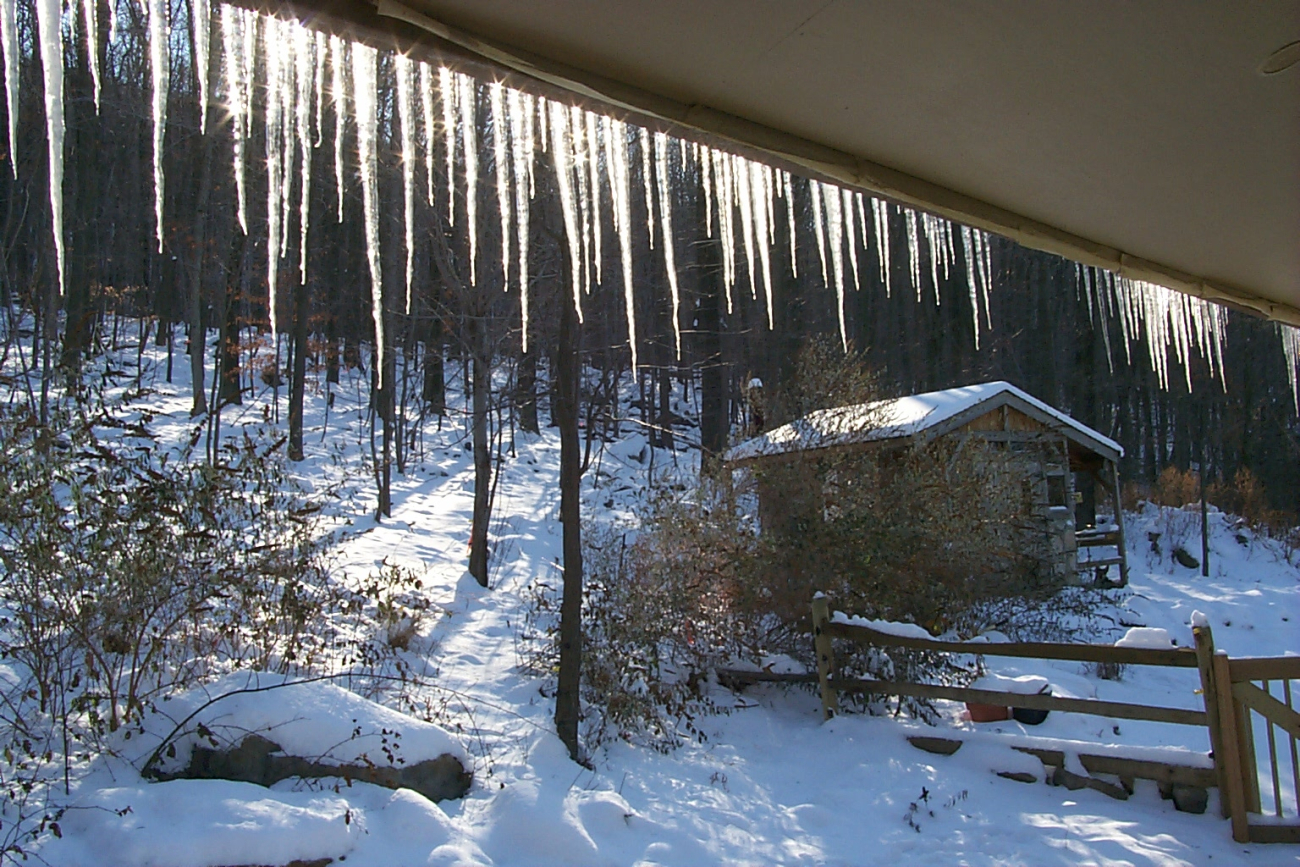 Icicles on the south side of a home illuminated on a bright winter morning