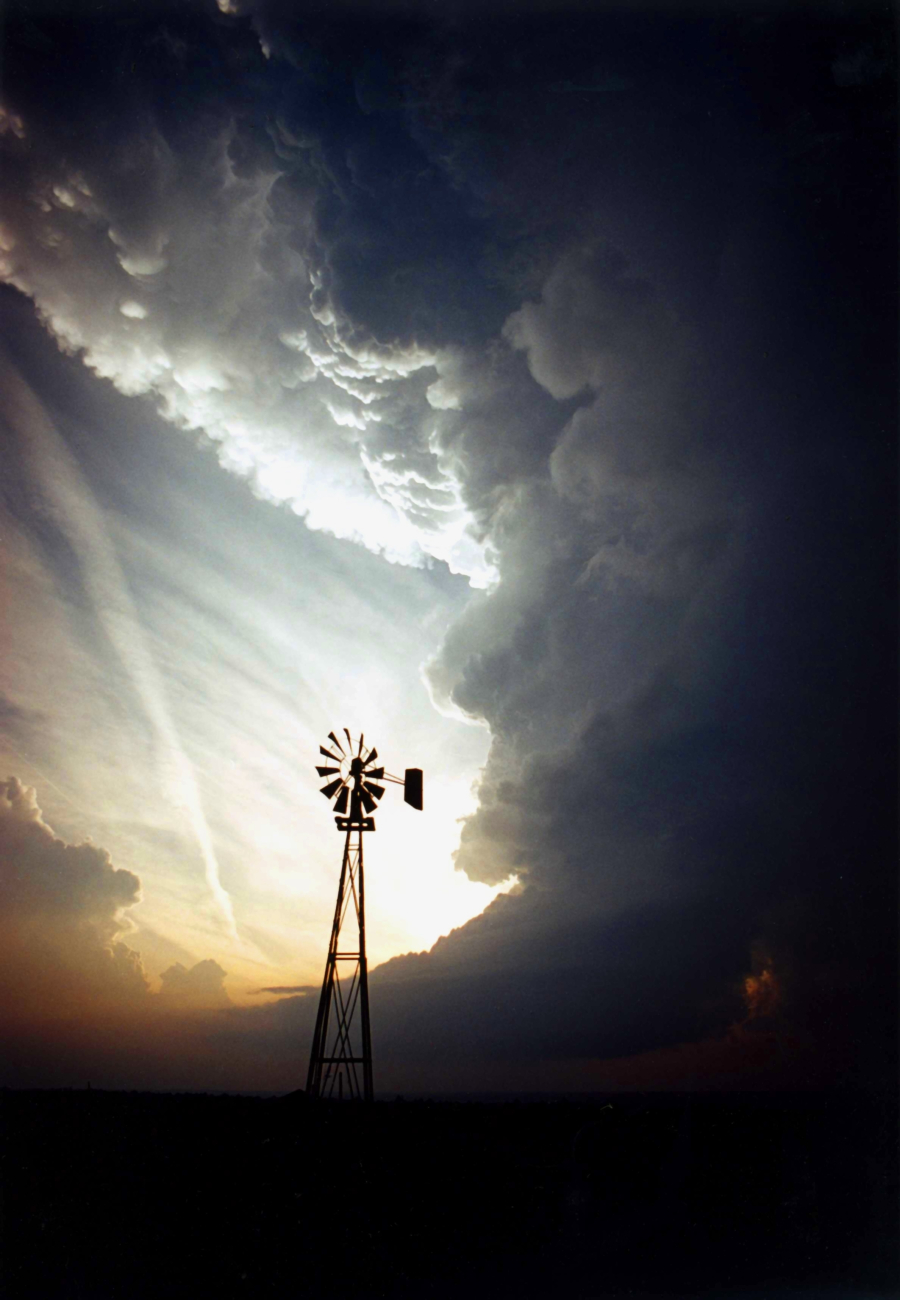 A windmill standing alone against a supercell thunderstorm